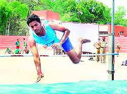 An aspirant takes part in a high jump event during the recruitment camp in Amritsar on Tuesday