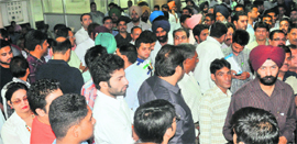 A large number of applicants stand outside the room for the auction at the RLA office in Sector 17 of Chandigarh on Tuesday.