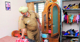 A police official checks the room where theft was committed at a house in Sector 29 of Chandigarh on Tuesday.