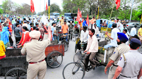 Members of Door-to-Door Garbage Collection Society block a light point in Sector 25, Chandigarh, on Tuesday.