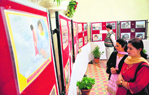 Visitors at an exhibition on the life and messages of Satya Sai Baba at the Gaiety Theatre in Shimla.