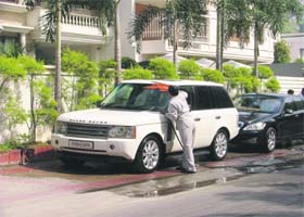 A man washes a car near the Government College for Women in Ludhiana on Tuesday