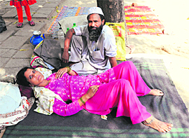 Rukhsana of Bijnore lies beside her husband at the PGI in Chandigarh on Wednesday.