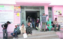 Patients wait for doctors outside District Hospital, Reasi,