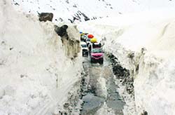 Vehicles cross the Zojila on Wednesday as the Srinagar-Leh highway reopened to traffic after five months Photo: Amin War