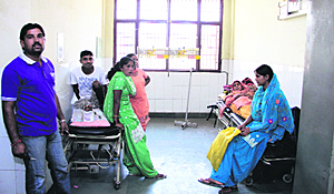 Patients wait in the corridor of the Civil Hospital's trauma ward in Jalandhar on Wednesday.