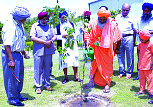 Environmentalist Baba Balbir Singh Seechewal plants a sapling at Pushpa Gujral Science City in Kapurthala on Wednesday.