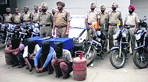 The arrested gang members along with recovered goods in Phagwara. 