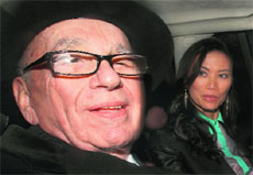 News Corp chief Rupert Murdoch (L) with his wife Wendi Deng in London on Wednesday.