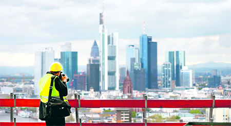 A photographer takes a picture of the skyline during a guided tour of the construction site of the new headquarters of the European Central Bank in Frankfurt am Main, the largest financial centre in the eurozone, on Thursday. The ECB, which currently occupies the citys Eurotower, plans to move its headquarters in early 2014