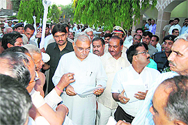 Chief Minister Bhupinder Singh Hooda listens to public grievances at PWD Rest House in Sonepat. 