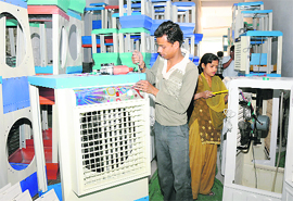 Workers assemble desert coolers at a market in Karnal.