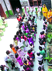 What to think of playing games, students attend the morning assembly in a congested courtyard at a government school in Ludhiana