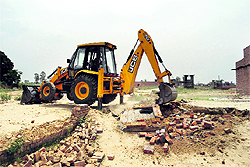 GLADA dismantles internal development works in an unauthorised colony on Tajpur road in Ludhiana on Thursday