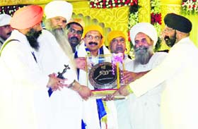 Sikh leaders felicitate Karnataka Chief Minister DV Sadananda Gowda (centre) at the inaugural function to mark the 500th anniversary of the Nanak Jhira Samagam at Bidar in Karnataka on Thursday