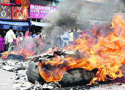 Relatives of a woman, who was found dead under mysterious circumstances, burn tyres in protest against the police in Haridwar on Friday. 