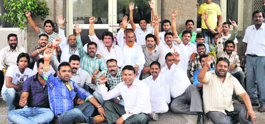 Members of the Nigam Safai Mazdur Union lock gates and lay siege to the entrance point of the Muniicipal Corporation office in Jalandhar on Friday.