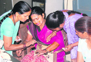 Cook Nirmala being attended to by school staff after the fire incident in Junior Model School in Jalandhar 