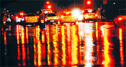 Colours are reflected on a road during rain in Chandigarh on Saturday