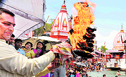 A teerth purohit perform aarti on the occasion of Ganga Saptami at Brahamkund, Har-ki-Pauri, in Haridwar on Saturday