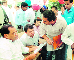 Revenue Minister and president of the state Congress Yashpal Arya listens to the problems of Bazpur residents on Saturday