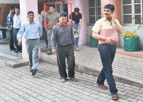 The accused in the bribe case being brought by the Vigilance team to the court in Mandi