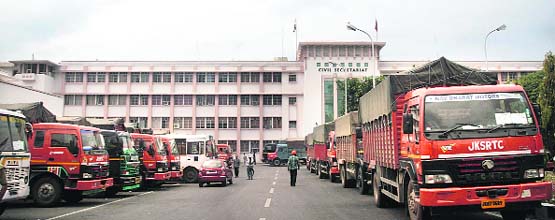 Trucks queue up at the Civil Secretariat for carrying official records to the Valley, in Jammu 