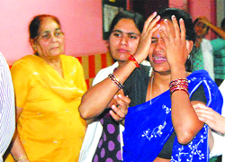 The inconsolable wife of Sunil Yadav in Jalandhar on Saturday.