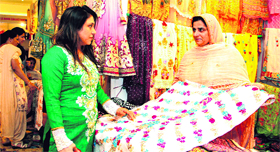 Bushra, a boutique owner from Lahore, shows her collection during an exhibition of bridal wear in Jalandhar on Saturday.
