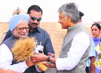CLP leader Sunil Jakhar greets PM Manmohan Singh at IAFs Bhisiana base near Bathinda.