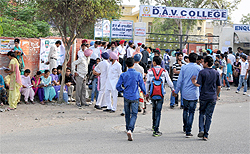 Parents stand outside the DAV College, which was also one of the centres for the exam in Bathinda on Sunday
