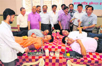 Members of the Sood Bhawan donate blood at a camp in Chandigarh on Sunday. 