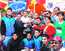 The winners of the Anil Godiyal Memorial Six-a-Side Cricket Tournament wih the winning trophy in Mussoorie on Sunday