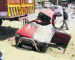 The damaged car after meeting with an accident with a parked truck on the GT Road near Bahalgarh on Saturday night.