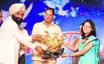 Neeju Gupta being felicitated on behalf of local residents by the SP, Devender Yadav (centre), at Ellenabad in Sirsa on Sunday.