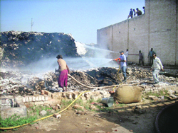 Fire services officials try to extinguish the fire that broke out in a cotton factory at Sirsa