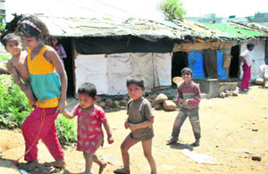 Rohingya children outside their makeshift houses in a slum in Jammu. 