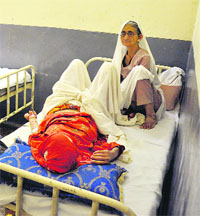 Two patients are forced to share a single bed in the ward
