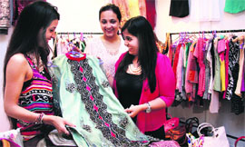 Girls look at the latest designs of bridal wear during an exhibition in Jalandhar on Sunday.