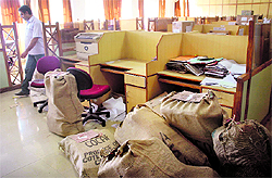 Files lying in a government office; gunny bags containing files being loaded on to a truck; vehicles outside the Secretariat