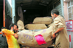 Files lying in a government office; gunny bags containing files being loaded on to a truck; vehicles outside the Secretariat