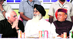 Union Human Resource Development Minister Kapil Sibal, Punjab Chief Minister Parkash Singh Badal and his Himachal Pradesh counterpart Prof Prem Kumar Dhumal at a function in Jalandhar on Sunday