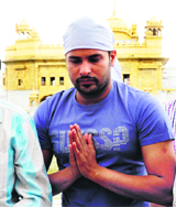 Singer-actor Amrinder Gill pays obeisance at the Golden Temple in Amritsar on Monday.