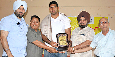 OP Singh (centre) being felicitated by the Malwa College authorities in the presence of the head of the District Athletic Association, KPS Brar (extreme left), at a function held in the college in Bathinda on Monday.