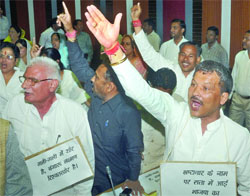 Members of the opposition raise slogans against the BJP during the swearing-in ceremony of the North MCD Mayor, Deputy Mayor and councillors in New Delhi on Monday