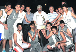 Members of Delhi Public School, New Delhi, who lifted the All-India Afzal Khan Basketball Tournament, with the winning trophy at Doon School in Dehradun