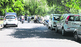 The vehicles parked on both sides of a road on the Jammu University campus.