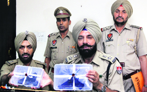 The Senior Superintendent of Police shows country-made pistols in Jalandhar on Monday.