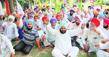 Farmers hold a protest against the proposed land acquisition in Amritsar on Monday. 