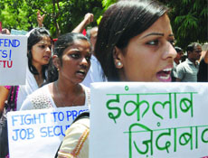 Hundreds of working class people under the banner of the International Federation of Trade Unions (Delhi) stage a dharna in protest against retrenchments at Jantar Mantar in New Delhi on Tuesday. 